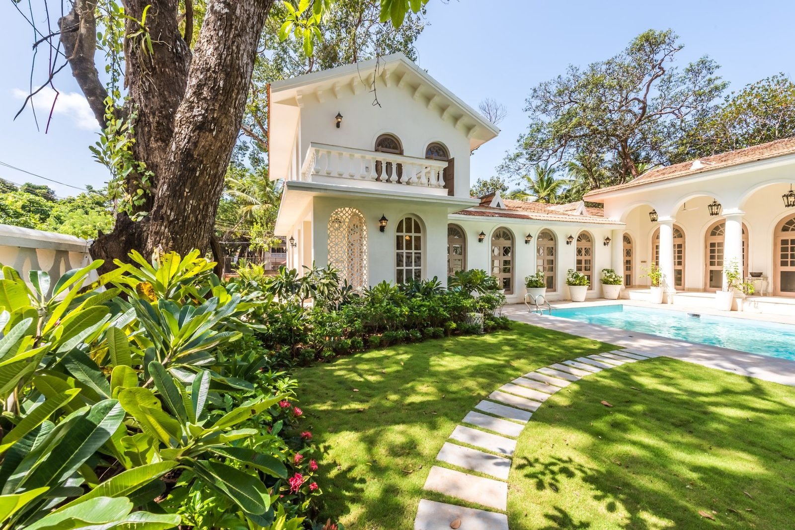 Stone-paved garden walkway with lawn strips