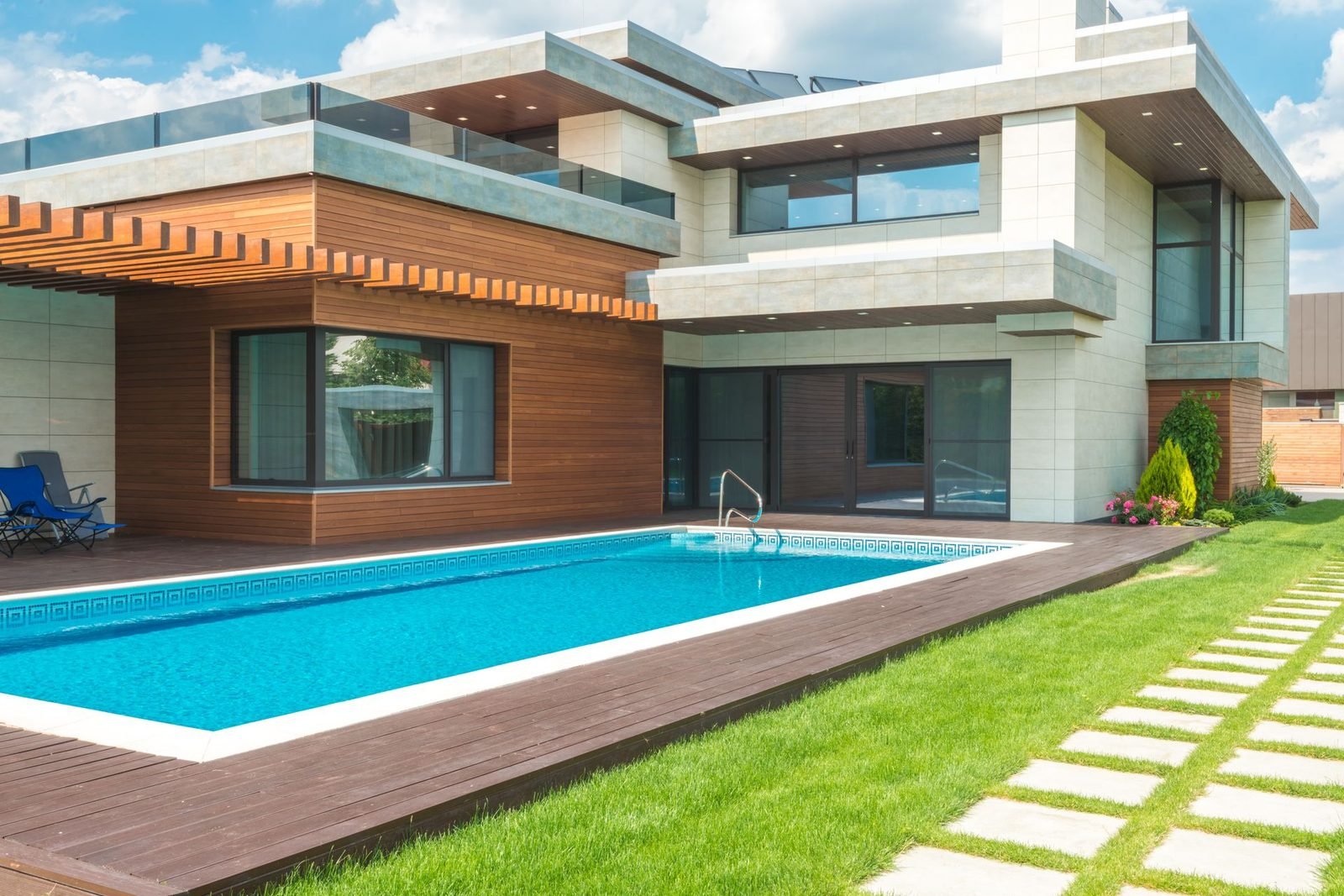 Clean blue swimming pool beside a villa